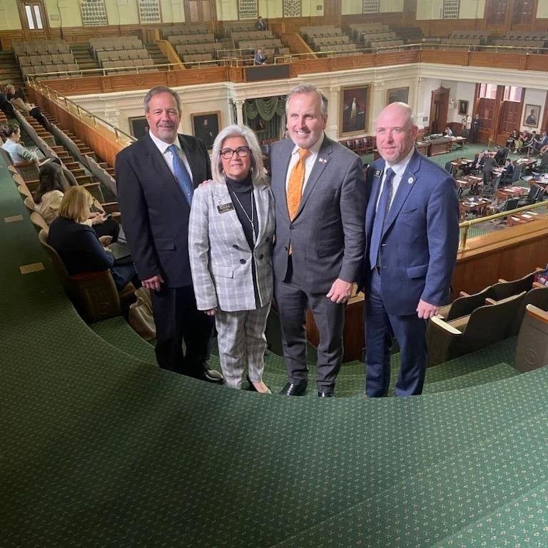 Mineola City Manager Mercy Rushing, with husband Tim (left), Texas Sen. Bryan Hughes of Mineola and city marketing
director Owen Tiner (right) were in the Senate chamber in Austin last week for the resolution honoring the city’s 150th anniversary. It was also presented by Rep. Cole Hefner in the Texas House.
